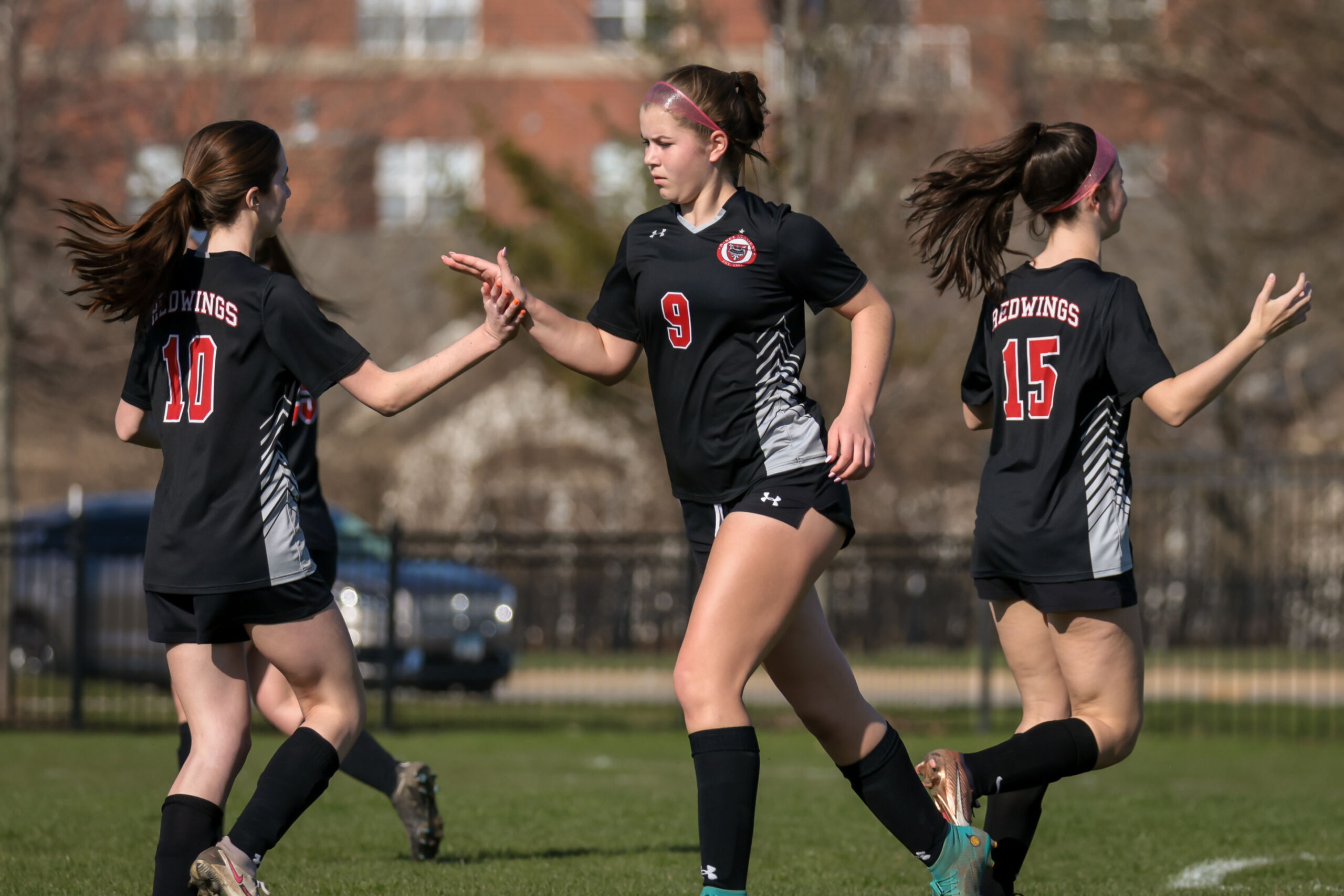 High school student playing soccer at Benet Stadium